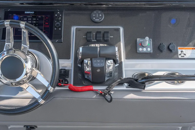 Slide: The Image of 2022 Fountain 38 SC boat dashboard with steering wheel and control panel. - 31