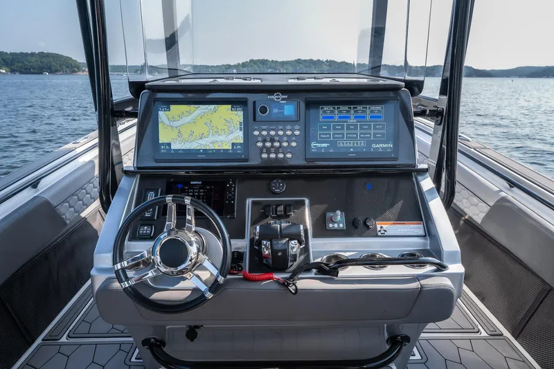 Slide: The Image of Cockpit of 2022 Fountain 38 SC boat with advanced navigation systems and steering wheel. - 30