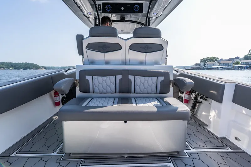 Slide: The Image of 2022 Fountain 38 SC boat interior with modern seating and scenic water view. - 25
