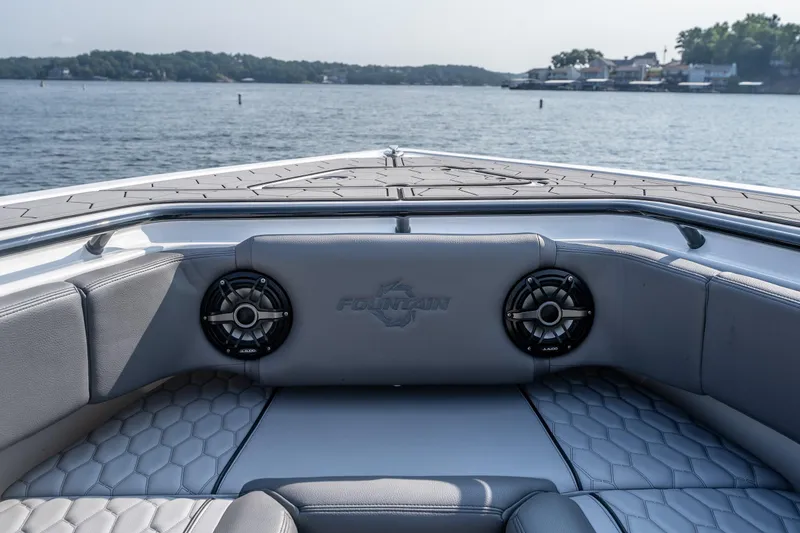 Slide: The Image of 2022 Fountain 38 SC boat interior with speakers, on a calm lake. - 13