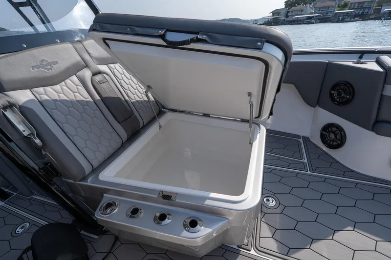 Slide: The Image of 2022 Fountain 38 SC boat interior with open storage compartment and stylish seating. - 42