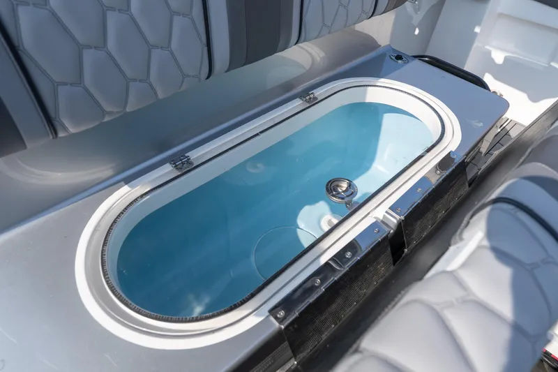 Slide: The Image of 2022 Fountain 38 SC boat interior with sleek seating and built-in storage compartment. - 39