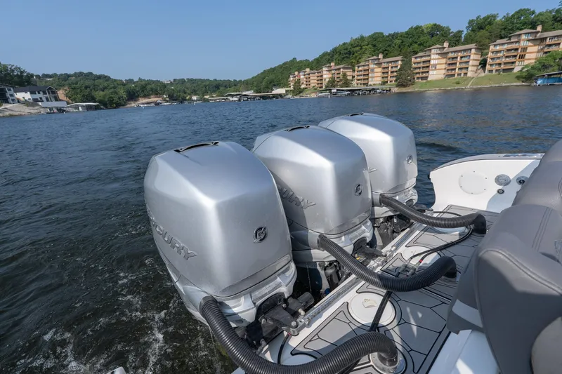 Slide: The Image of 2022 Fountain 38 SC boat with triple Mercury outboard engines on a scenic lake. - 27