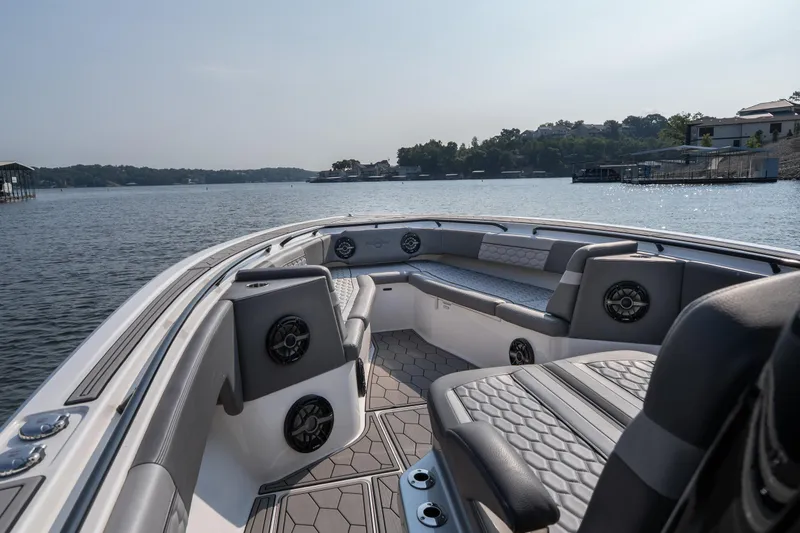 Slide: The Image of 2022 Fountain 38 SC boat interior with luxurious seating on a serene lake. - 9