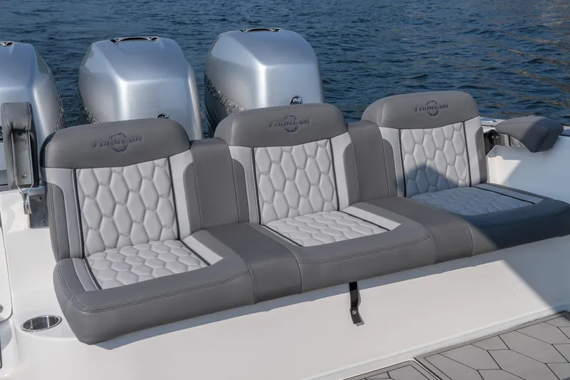 Slide: The Image of Luxury seating on 2022 Fountain 38 SC boat with triple outboard engines. - 24