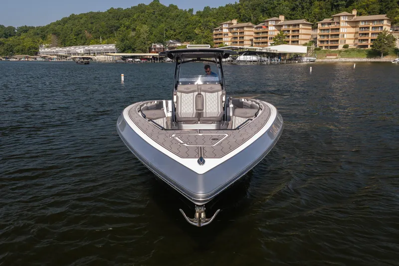 Slide: The Image of 2022 Fountain 38 SC boat on a lake with scenic shoreline and buildings in the background. - 5