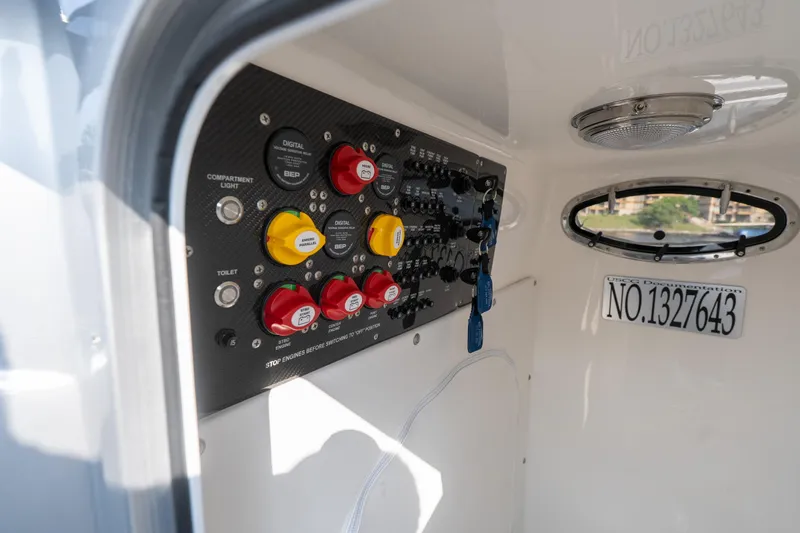 Slide: The Image of Control panel inside 2022 Fountain 38 SC boat, featuring switches and documentation number. - 22