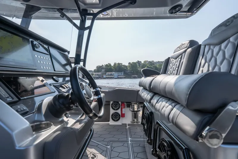 Slide: The Image of Interior view of 2022 Fountain 38 SC boat, featuring modern dashboard and luxurious seating. - 34