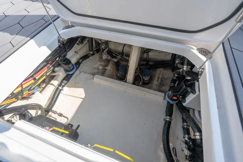 Slide: The Image of Engine compartment of a 2022 Fountain 38 SC boat, showcasing wiring and components. - 38