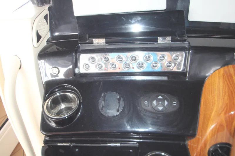 Slide: The Image of Control panel of 2024 HCB 42 Lujo boat with switches and cup holder. - 29