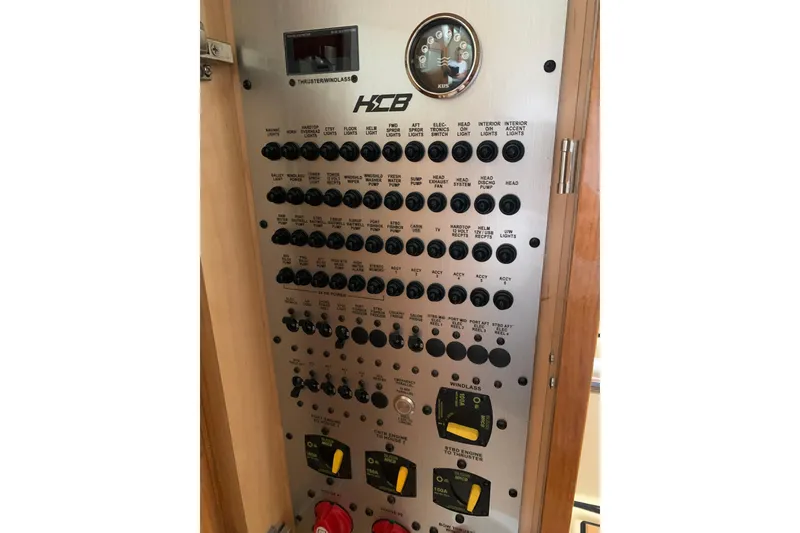 Slide: The Image of Control panel of 2024 HCB 42 Lujo boat with various switches and gauges. - 61