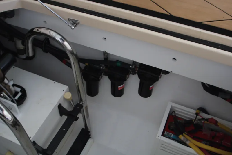 Slide: The Image of 2024 HCB 42 Lujo boat interior showing engine compartment and tools. - 88