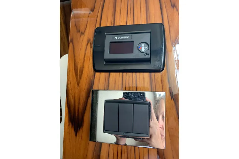 Slide: The Image of Control panel and switches on HCB 42 Lujo 2024 yacht, featuring wood finish. - 55