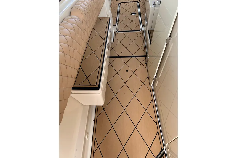 Slide: The Image of 2024 HCB 42 Lujo boat interior with diamond-patterned flooring and quilted seating. - 48