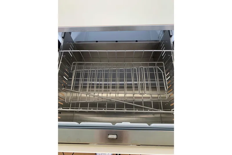 Slide: The Image of Open stainless steel drawer with wire rack inside, part of HCB 42 Lujo 2024 model. - 46