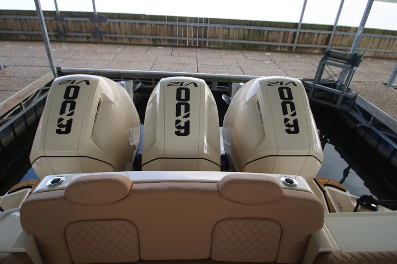 Slide: The Image of 2024 HCB 42 Lujo boat with triple 400 V12 engines, docked in a marina. - 67