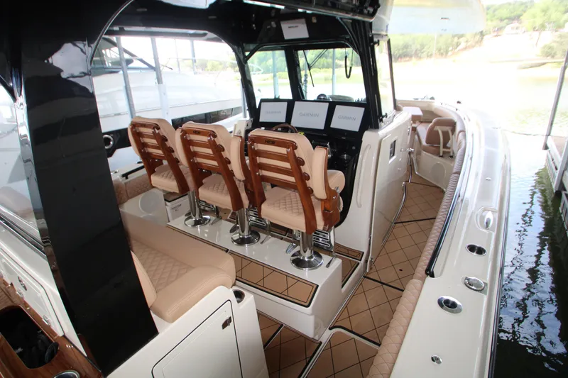 Slide: The Image of 2024 HCB 42 Lujo boat interior with luxurious seating and advanced navigation displays. - 14