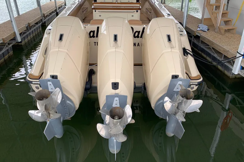 Slide: The Image of 2024 HCB 42 Lujo boat with triple outboard engines docked in marina. - 70