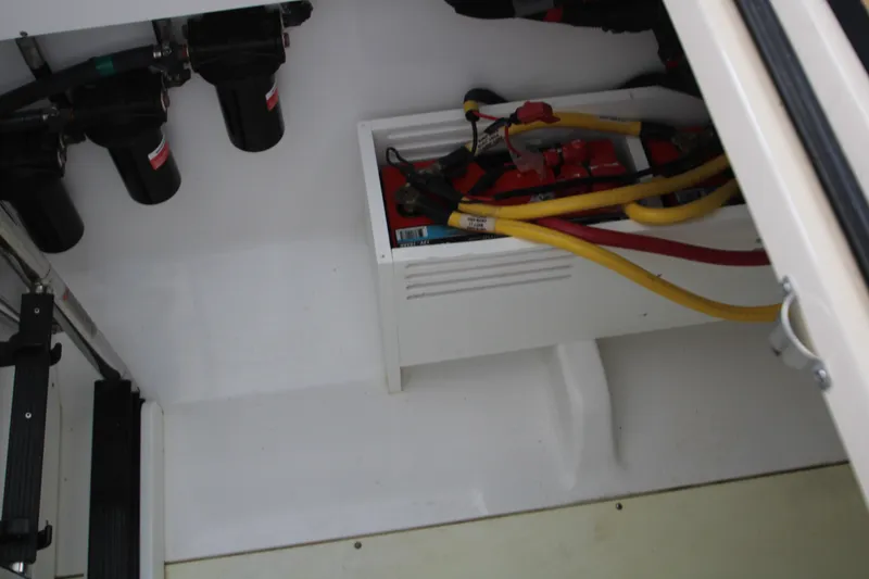 Slide: The Image of 2024 HCB 42 Lujo boat electrical compartment with wiring and components. - 90