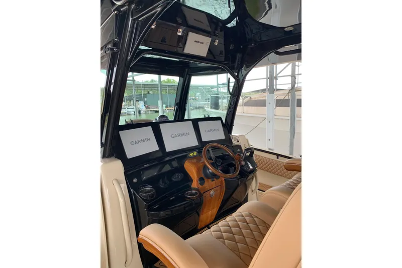 Slide: The Image of Luxurious 2024 HCB 42 Lujo boat cockpit with Garmin navigation displays and plush seating. - 34