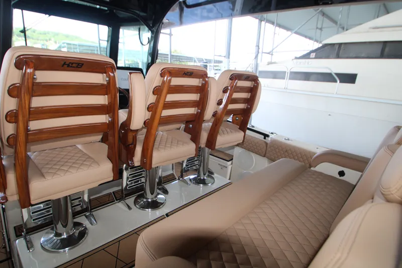 Slide: The Image of Luxurious interior of 2024 HCB 42 Lujo boat with elegant seating and wood accents. - 15
