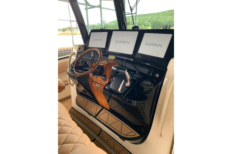 Slide: The Image of Helm of 2024 HCB 42 Lujo boat with Garmin displays and luxurious wood accents. - 22