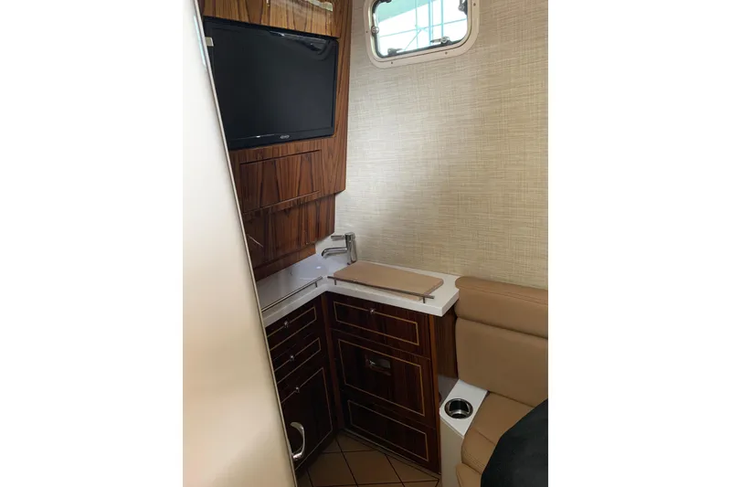 Slide: The Image of Interior of 2024 HCB 42 Lujo yacht featuring a compact kitchenette and seating area. - 53