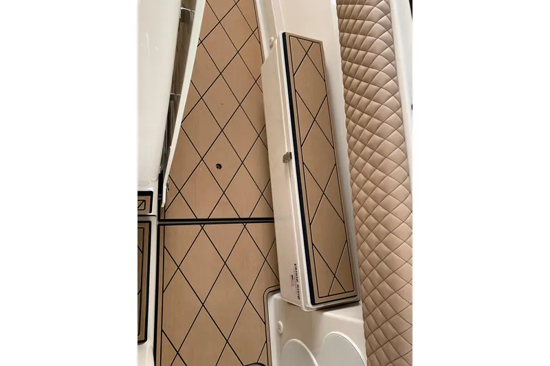 Slide: The Image of 2024 HCB 42 Lujo boat interior with diamond-patterned flooring and quilted seating. - 50
