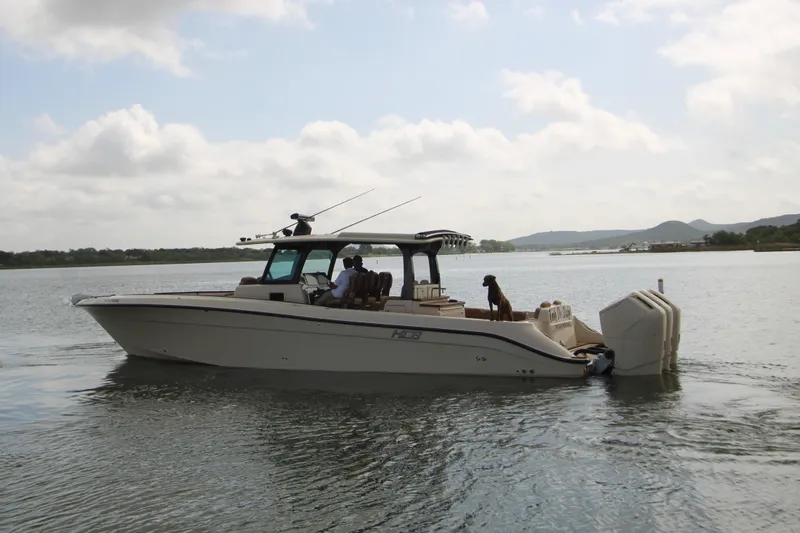 Slide: The Image of 2024 HCB 42 Lujo boat cruising on calm waters under a cloudy sky. - 1
