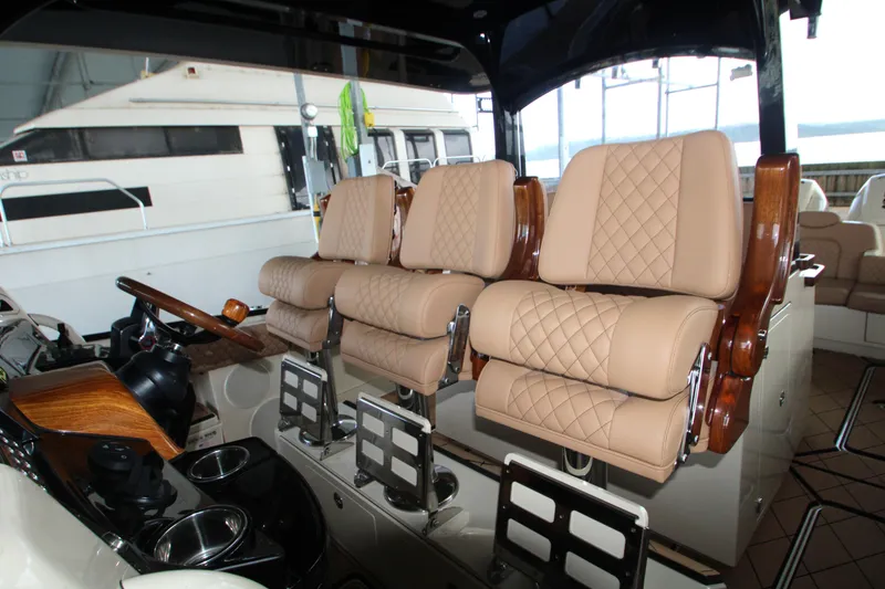 Slide: The Image of Luxurious seating on 2024 HCB 42 Lujo boat, featuring quilted leather and wood accents. - 13