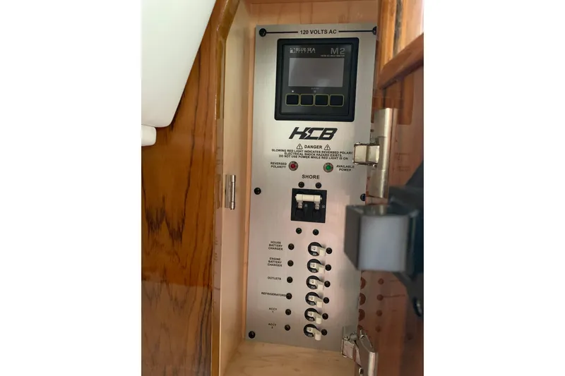 Slide: The Image of Electrical panel inside 2024 HCB 42 Lujo boat, featuring control switches and display. - 62