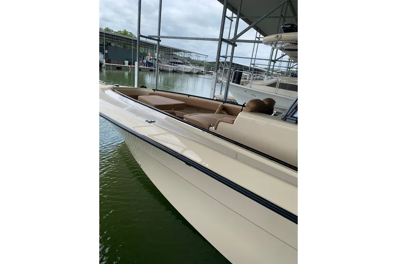 Slide: The Image of 2024 HCB 42 Lujo luxury boat docked in marina, showcasing sleek design and comfortable seating. - 80