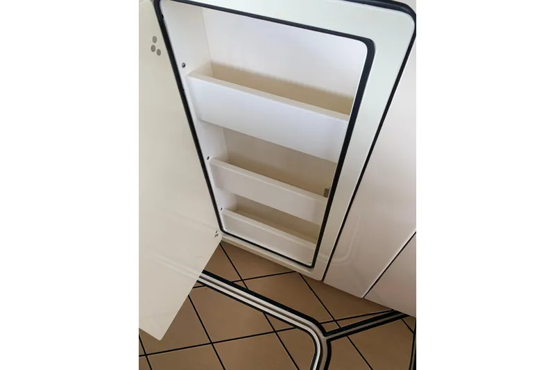 Slide: The Image of Open storage compartment on 2024 HCB 42 Lujo boat, featuring sleek interior design. - 45
