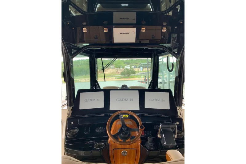 Slide: The Image of Helm of 2024 HCB 42 Lujo boat with Garmin displays and wooden steering wheel. - 35