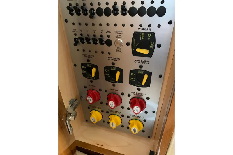 Slide: The Image of Control panel of 2024 HCB 42 Lujo boat with switches and circuit breakers. - 63