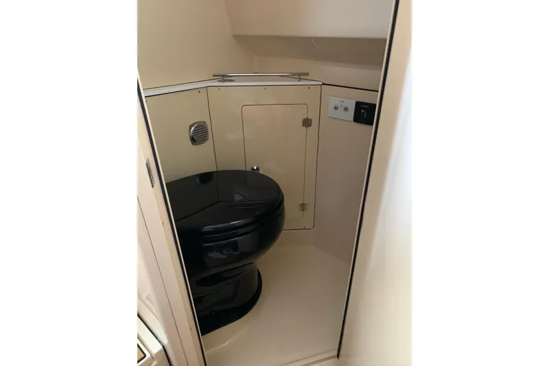Slide: The Image of 2024 HCB 42 Lujo boat bathroom with sleek black toilet and compact design. - 54