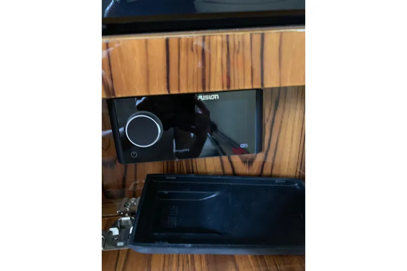 Slide: The Image of Control panel on 2024 HCB 42 Lujo boat, featuring a sleek wooden finish. - 59