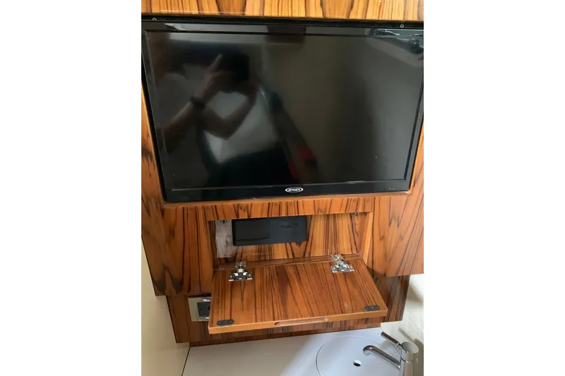 Slide: The Image of 2024 HCB 42 Lujo interior with mounted TV and wooden cabinetry. - 57