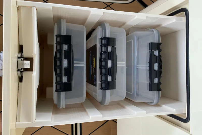 Slide: The Image of Storage compartment with organized plastic containers in HCB 42 Lujo, 2024 model. - 43