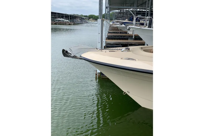 Slide: The Image of 2024 HCB 42 Lujo boat docked at marina, showcasing sleek bow design. - 77
