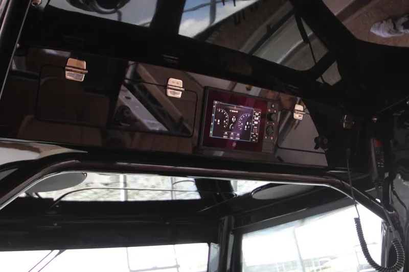 Slide: The Image of 2024 HCB 42 Lujo boat dashboard with advanced navigation display and controls. - 26
