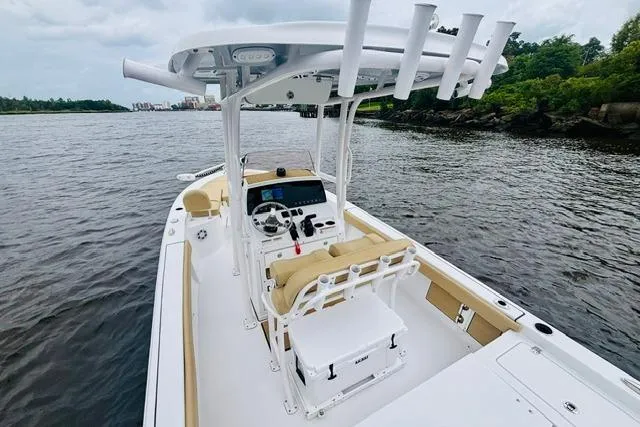 Slide: The Image of 2023 Sportsman Masters 227 Bay Boat on calm water, featuring a sleek design and modern console. - 7