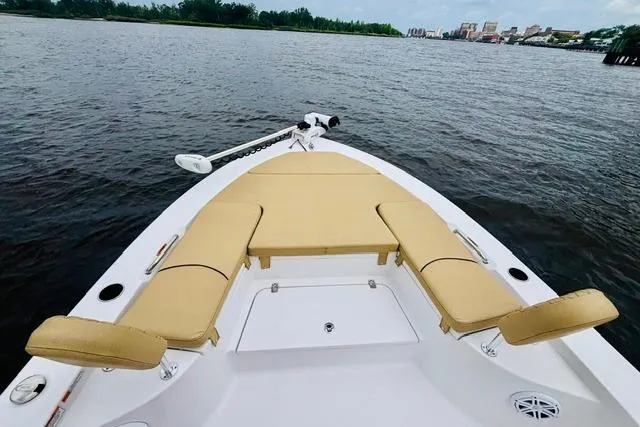 Slide: The Image of 2023 Sportsman Masters 227 Bay Boat with tan seating on calm water. - 11