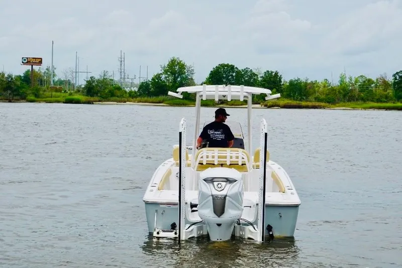 Slide: The Image of 2023 Sportsman Masters 227 Bay Boat on calm water, rear view. - 3