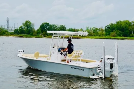 Slide: The Image of 2023 Sportsman Masters 227 Bay Boat on calm water, featuring sleek design and modern amenities. - 4