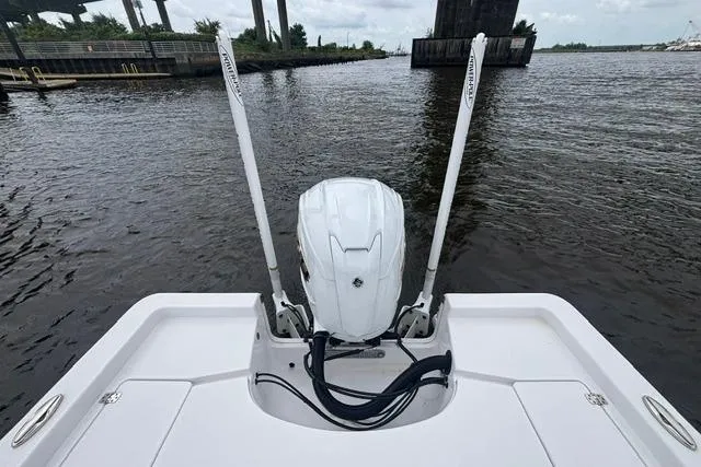 Slide: The Image of 2023 Sportsman Masters 227 Bay Boat with dual power poles on a calm river. - 8