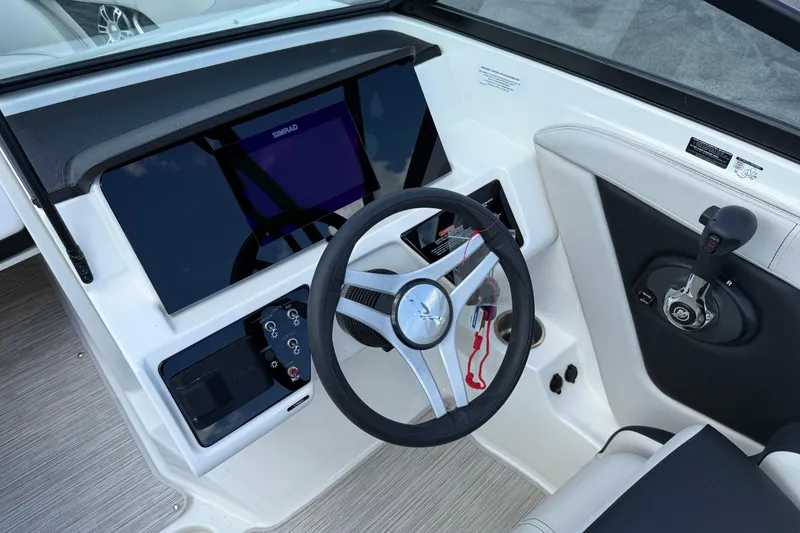 Slide: The Image of 2023 Sea Ray SPX 190 boat dashboard with steering wheel and control panel. - 13