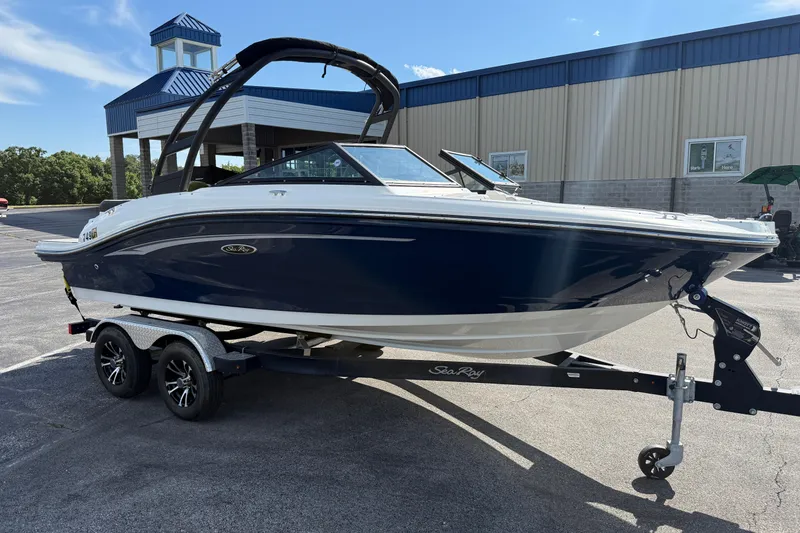 Slide: The Image of 2023 Sea Ray SPX 190 boat on trailer, parked outdoors near a building. - 3