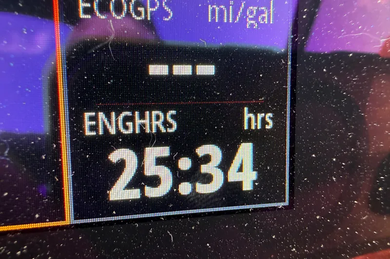 Slide: The Image of Display screen showing engine hours at 25:34 on a 2023 Sea Ray SPX 190 boat. - 32