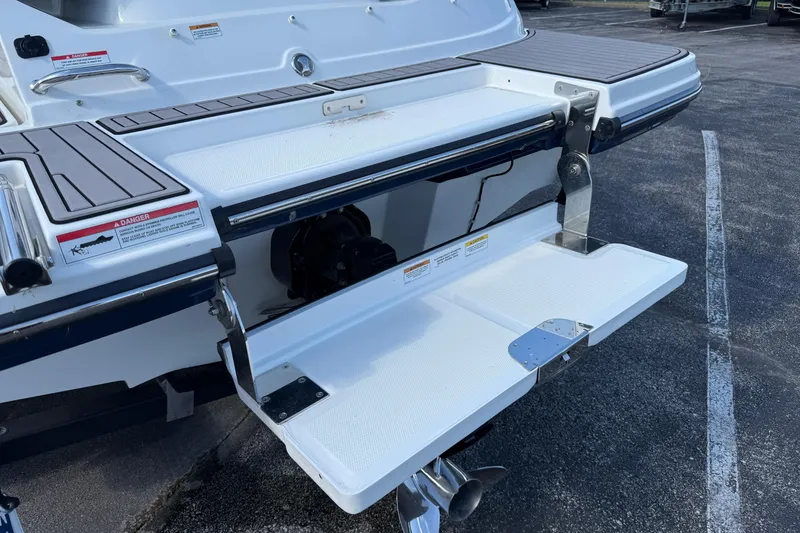 Slide: The Image of 2023 Sea Ray SPX 190 swim platform with foldable ladder and safety warnings. - 29